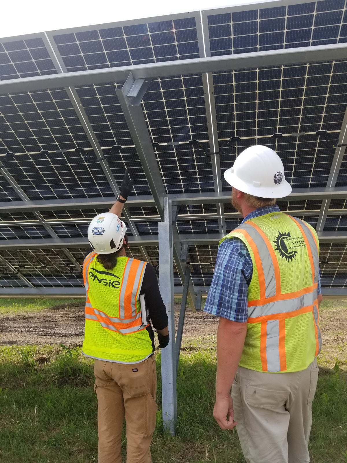 Male and Female looking under solar panel 