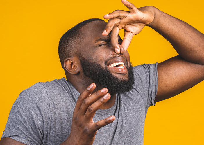 man pinching nose