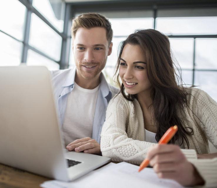 young couple looking at laptop