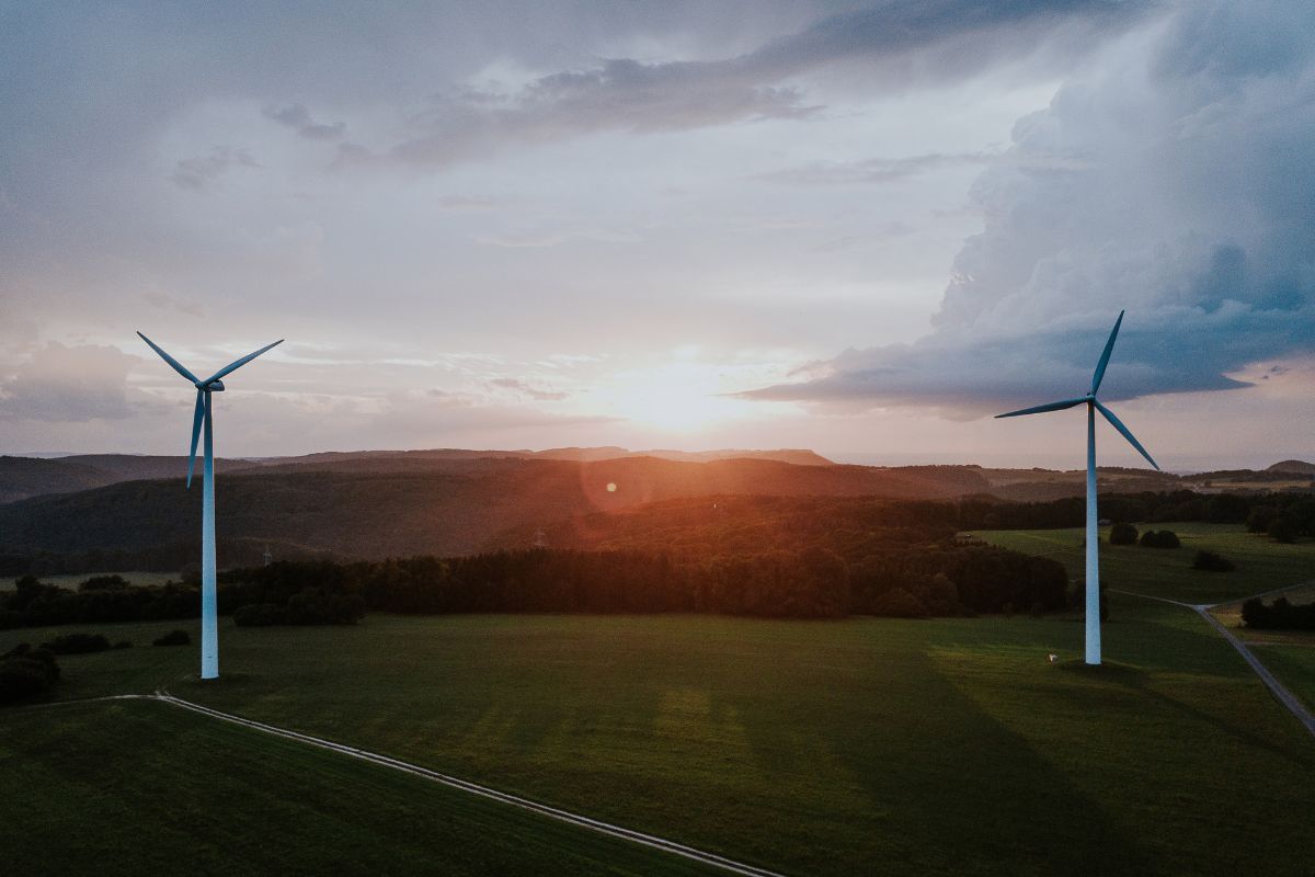 Two wind turbines at sunset.