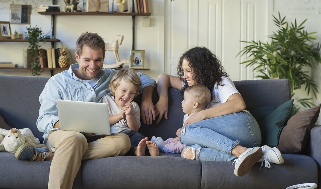 family on couch with laptop